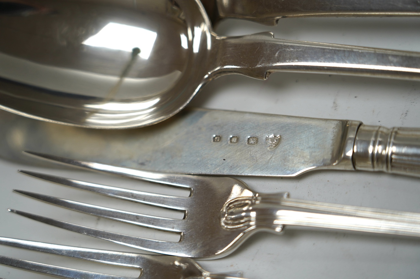 A pair of early Victorian Scottish silver tablespoons, John Pringle, Edinburgh, 1838, a silver fish knife, three assorted 19th century silver forks and a William IV silver fiddle, thread and shell pattern sauce ladle, 13